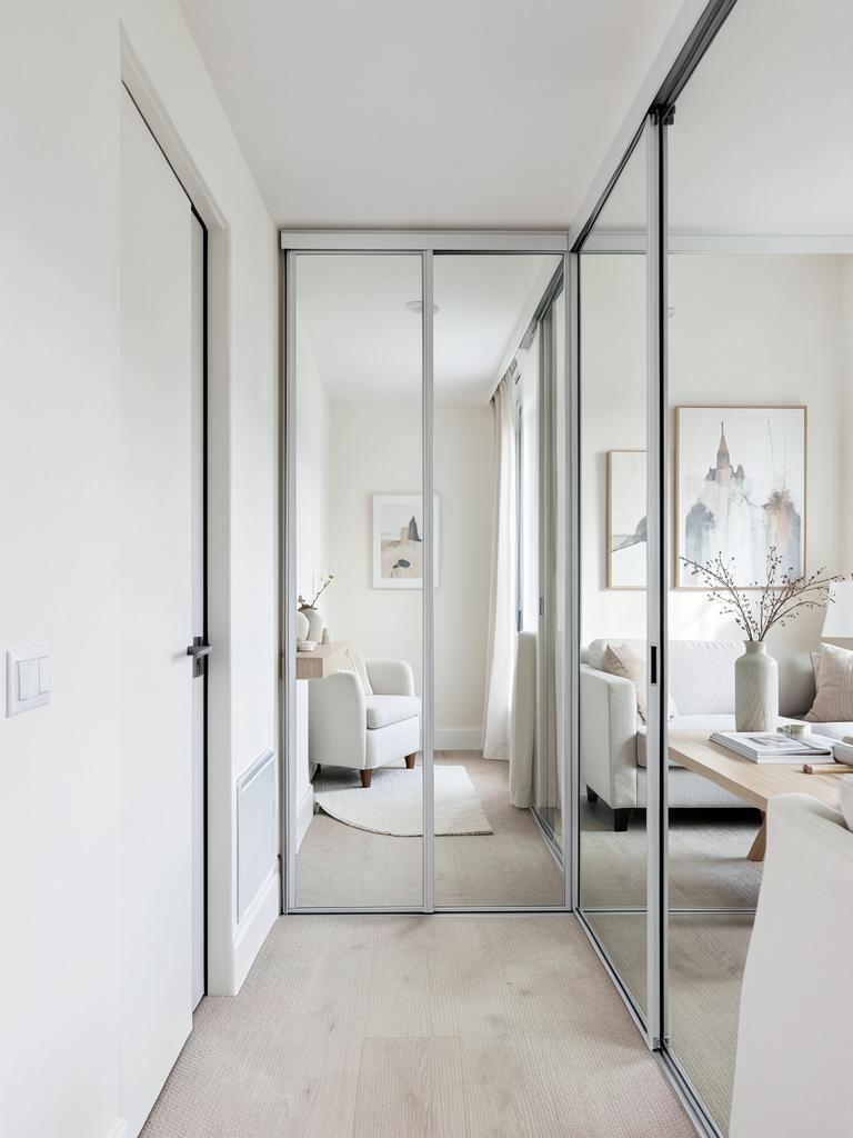 Mirror sliding doors mixed with grey solid panels in a bedroom in Treforest, Pontypridd